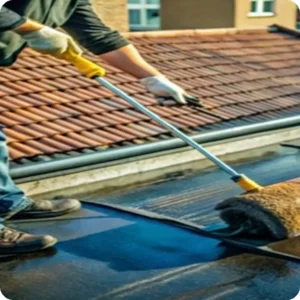Roof waterproofing solution being applied with a roller to prevent water leakage